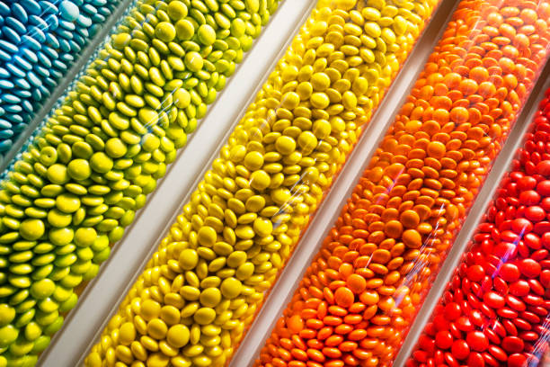 A variety of sweets displayed in a colorful arrangement, showcasing an assortment of candies and treats. The image is bright and inviting, with a playful and cheerful atmosphere.